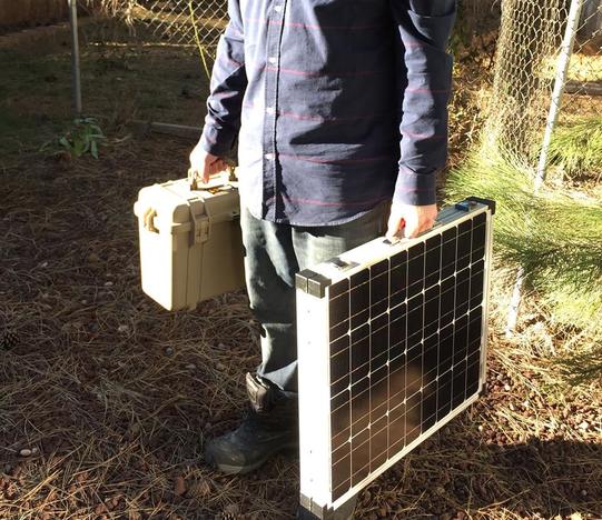 Carrying the case and folded solar panel by hand